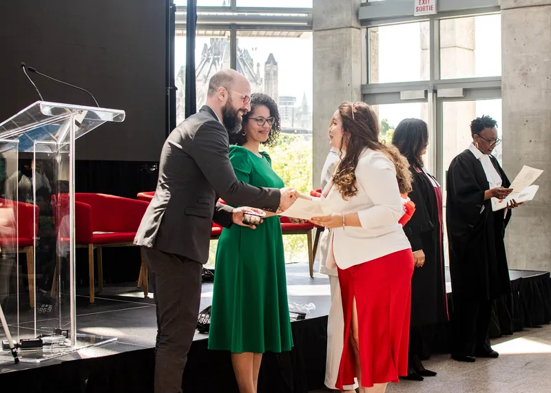 Daniel Bernhard greeting new Canadian citizen